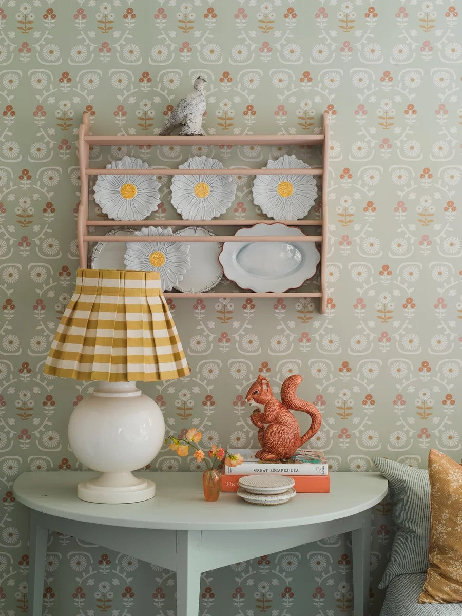 Colored in a beautiful, muted palette of light green with delightful pink, rust red, and mustard yellow details, our Isolde wallpaper offers a happy and welcoming feel.