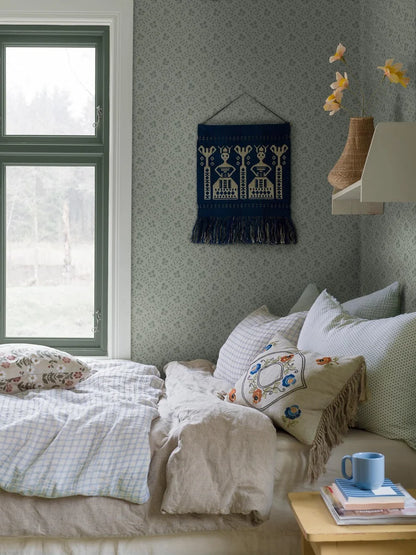 Colored on a tone-on-tone palette of grey green, our Idun wallpaper is contemporary and playful.