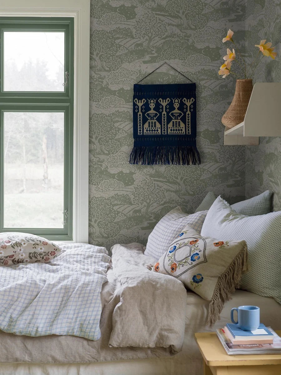 Featuring a soft yet vibrant warm green color scheme on a linen beige background, our Solängen wallpaper brings the lively spirit of nature indoors.