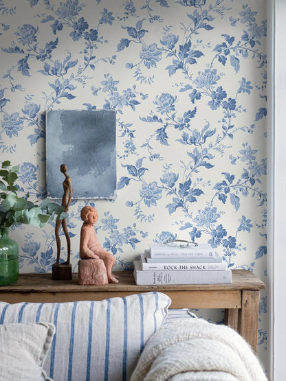 Reviving the charm of the late 1800s, our Blomslinga wallpaper in a traditional surface print, features delightful blue flowers and leaves on a fresh white base.