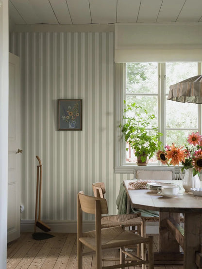 Our Gunnebo wallpaper in linden green has cream-colored stripes that bring a classic Gustavian elegance to any room.