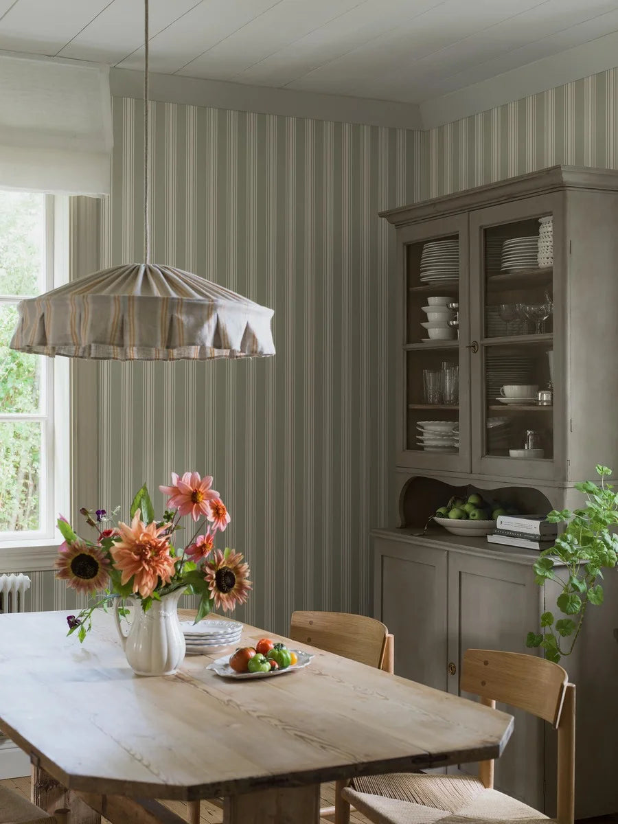 Our Gunnebo wallpaper in linden green has cream-colored stripes that bring a classic Gustavian elegance to any room.