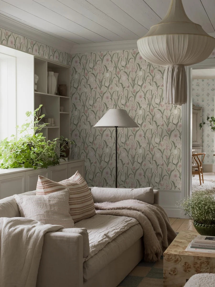 This La Belle Epoque wallpaper has a dreamy arrangement of powdery pink and cream tulips with silver-green leaves on a beige background.