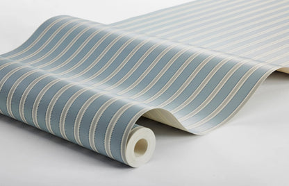 This Pärlband wallpaper is colored in muted blue and brown, on a light beige background, accented with dark blue dots.