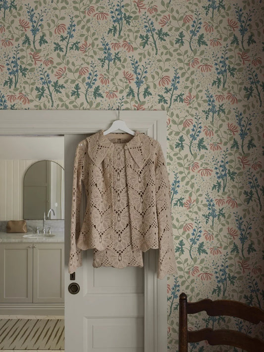 Trädgårdsfröjd wallpaper has a rich and multicolored floral pattern on a beige background.