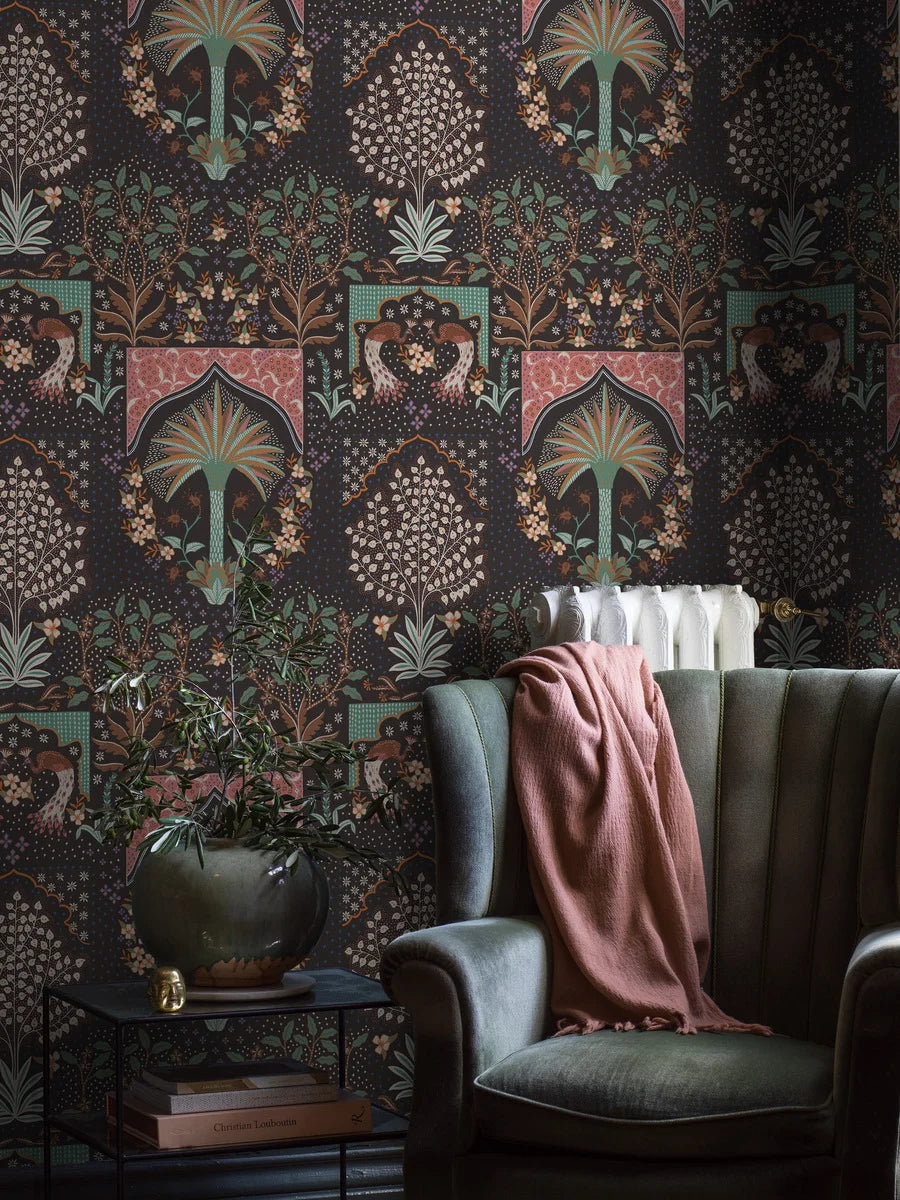 The dark wallpaper Peacock is richly decorated with an abundance of beautiful details. Here are palms, shrubs, trees, and flowers – and majestic peacocks, of course, as the name suggests