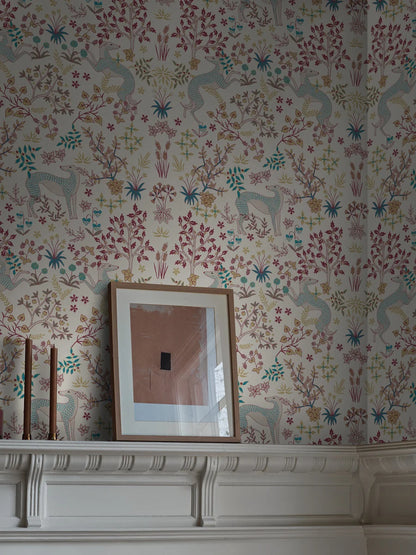 The light wallpaper Whippet is adorned with a playful, dense pattern of delicate vegetation and beautiful whippet dogs. 