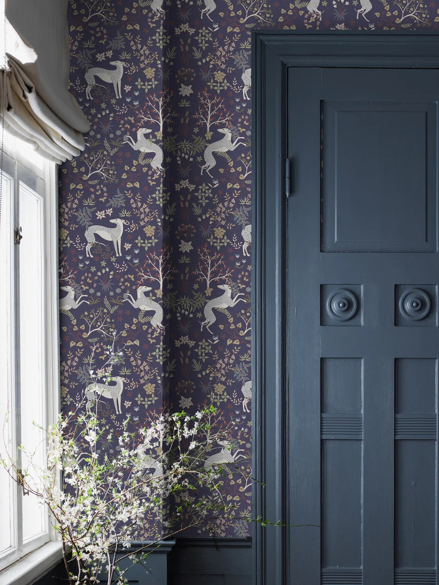 The dark wallpaper Whippet has a dense, richly decorated pattern of playful whippet dogs and delicate vegetation; foliage, flowers, fruits, berries, and swaying grass. 