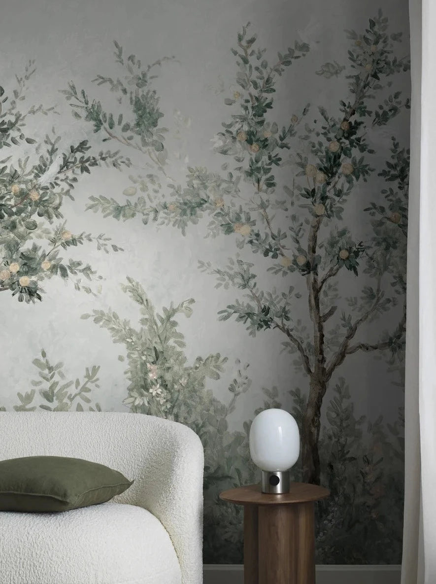 Lydia's Garden wallpaper offers a lush, hand-painted garden view with blooming bushes and white birds in laden fruit trees. 