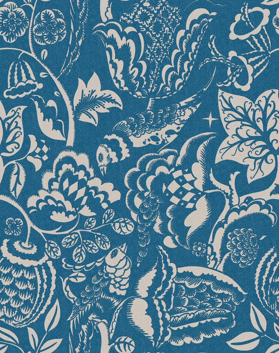 Wundervogel wallpaper in blue showcases whimsical birds and lush, winding plants in a large-scale pattern with modernist expressions evident in the pattern’s geometric and winding embellishments. 