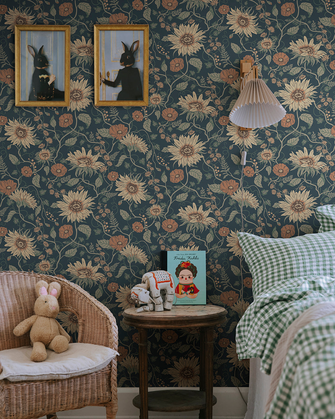 Wallpaper Solveig, Midnight Blue, has a deep blue base adorned by flowers in warm shades of yellow and terracotta red with green foliage.